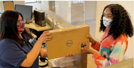 Image of student receiving loaner Dell laptop