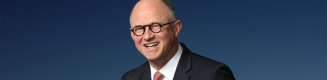 Photo of Vice Chancellor Marc Fisher on a blue background.